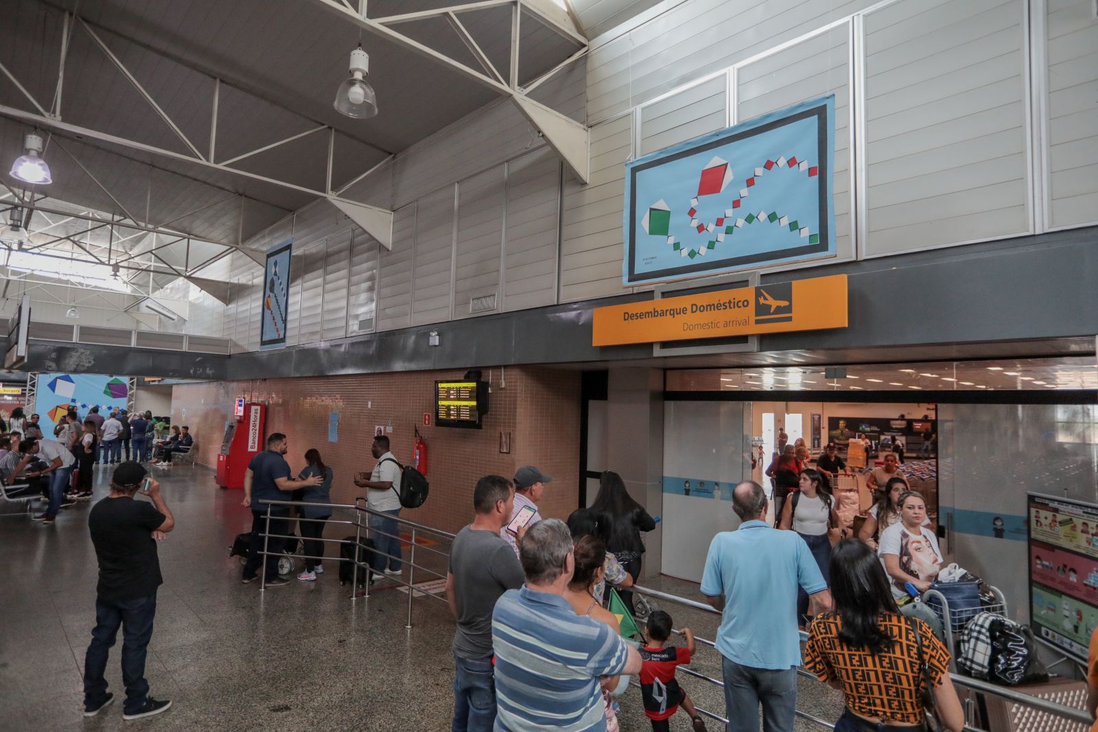 As telas estão distribuídas no saguão do aeroporto